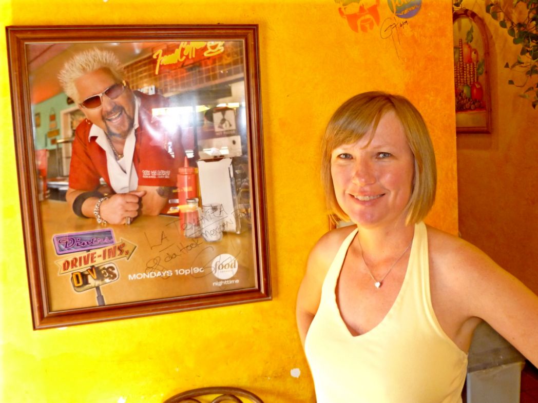 Anna in front of DDD Poster with Guy Fieri